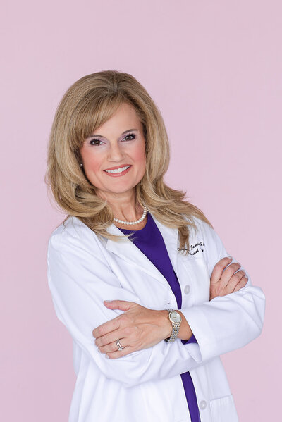 Headshot of female doctor on pink background