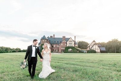 Georgia Wedding Photographer | Bride and Groom Walking at Sunset With Chateau Wedding Venue In The Background