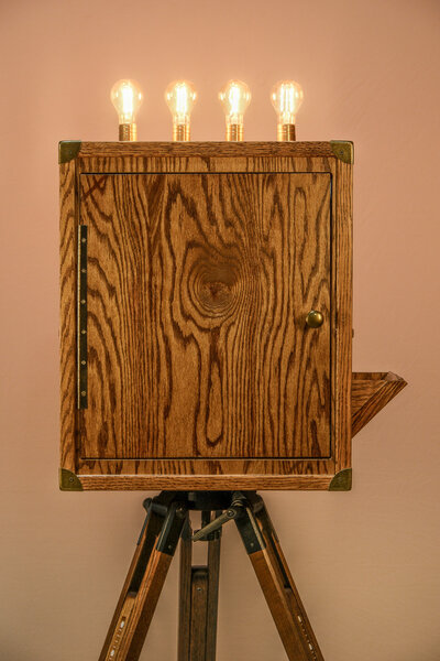 wood photo booth and bulbs on top