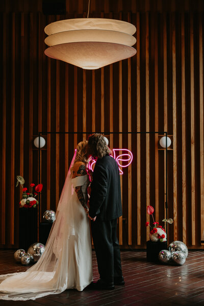 A bride and groom kiss during their ceremony at Ducie Street Warehouse in Manchester. 