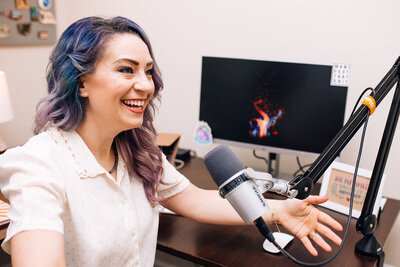 Jen Liss with a podcast microphone