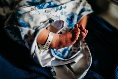 snuggly photo of baby girl during in home lifestyle newborn session in breaux bridge, louisiana