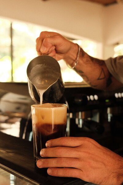 Milk being poured into coffee