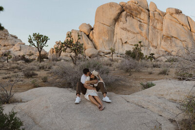 couple holding eachother on a rock