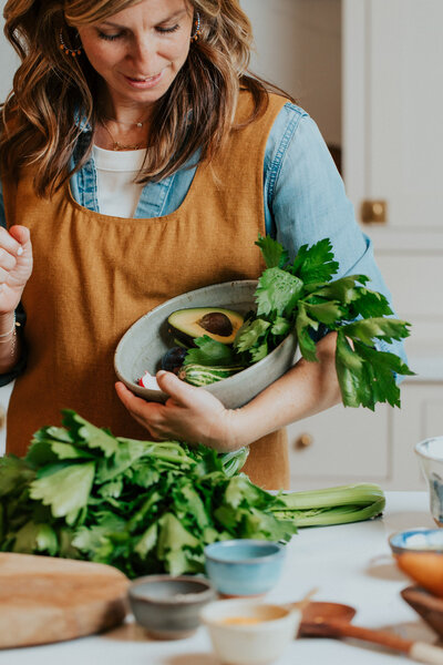 Sam holding a bowl of cilantro and avocados