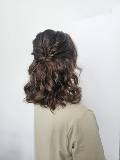 Soft half up half down hairstyle on thick brunette hair for beautiful bride at Rownhams House, Hampshire