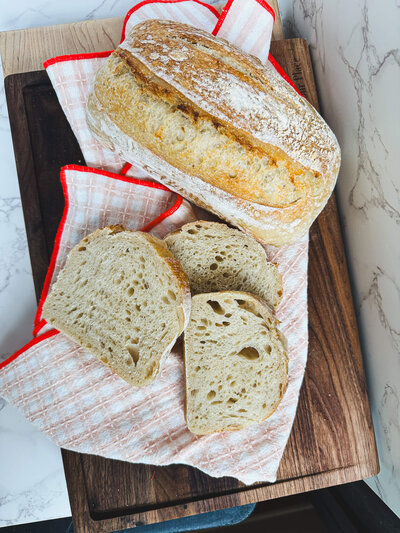 Fresh loaf of locally crafted artisan bread, sliced and ready to order.