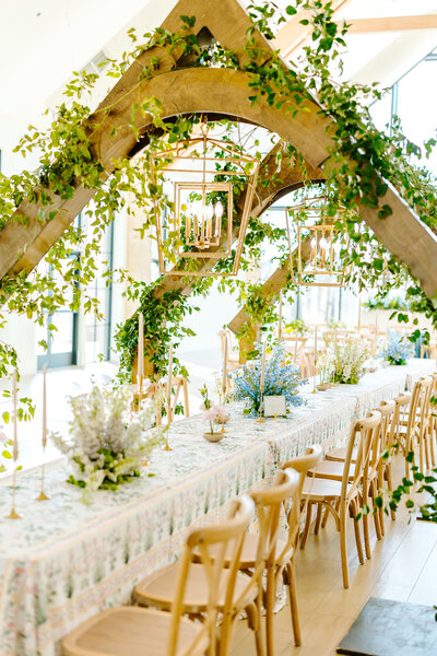 Elegant Southern garden-inspired wedding reception with floral arch, long table, and refined estate details in Oklahoma