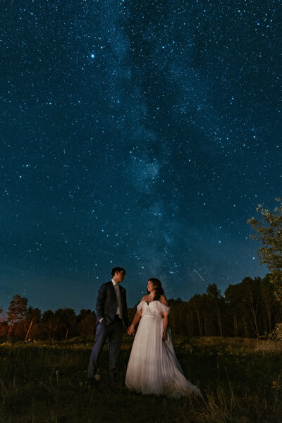 photo of man and woman sitting on outdoor stairs smiling at each other taken by Philly elopement photographer