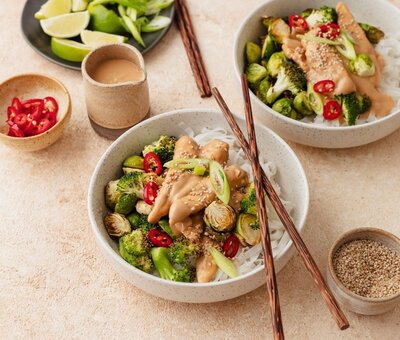 Hormone-supportive cashew ginger chicken with broccoli and rice noodles in a creamy tahini sauce