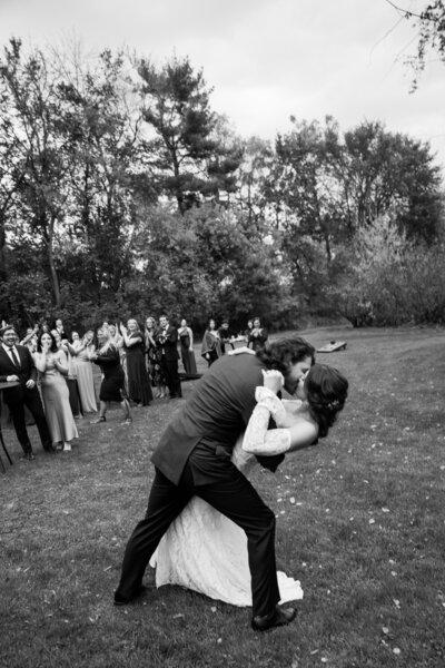 groom dipping his bride after their first dance 