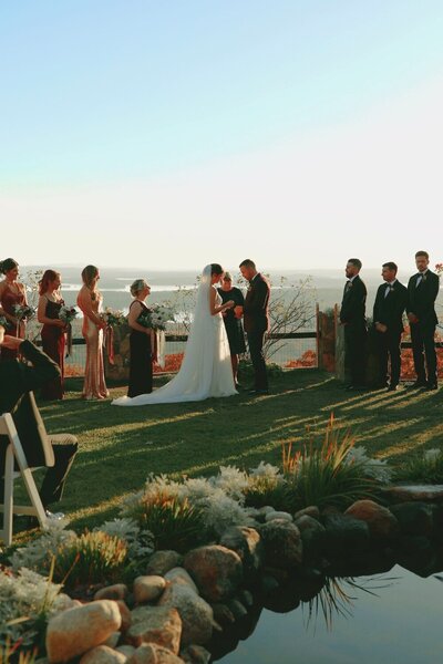 Castle in the Clouds - Bride and Groom with Entourage Overlooking Lake
