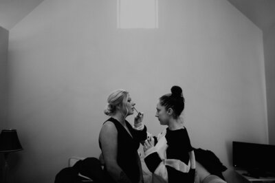 A bridesmaid has her lips done at a wedding in the UK. 