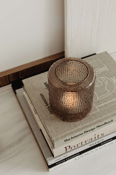 Vignette of books and candle on sideboard at Vancouver penthouse interior design project