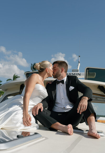 east coast wedding photography of bride and groom kissing on a yacht on wedding day taken by Shelby Ann Photos