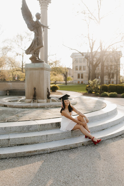 Kylie sitting on steps of college, for grad photos