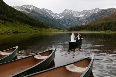 Adventurous elopement couple paddles out on a canoe at sunset