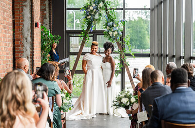 Brides at the custom triangle flower alter
