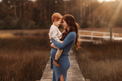 Expectant mother embraces her toddler during Maternity Photos in Charleston, SC.