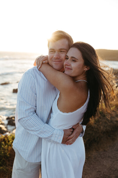 couple embracing each other on the beach 