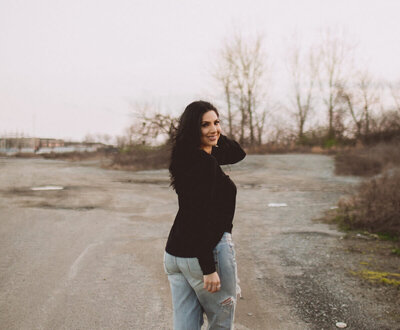 Angelica Ray walking outdoors, reflecting and reconnecting with nature inviting 1:1 connection and contact