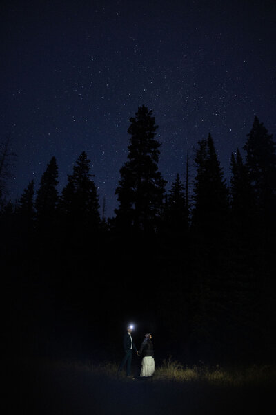 Bride and groom stargaze during Colorado hiking elopement.