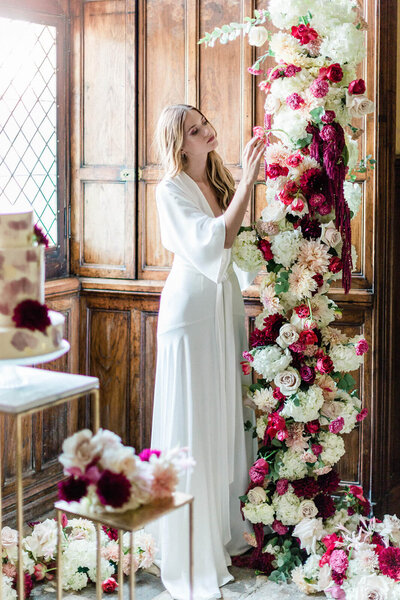 bride touching flowers at her wedding