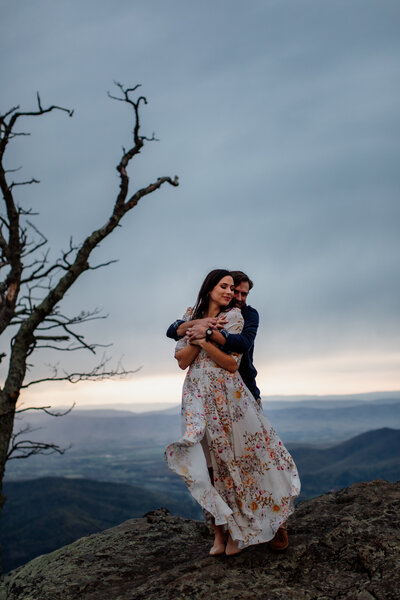 Couple hugging on mountaintop
