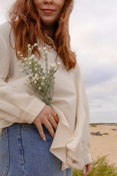 Carolin holding bunch of flowers close up