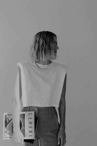 Delcy Garnaas looks to the side while holding a cereal magazine by her side