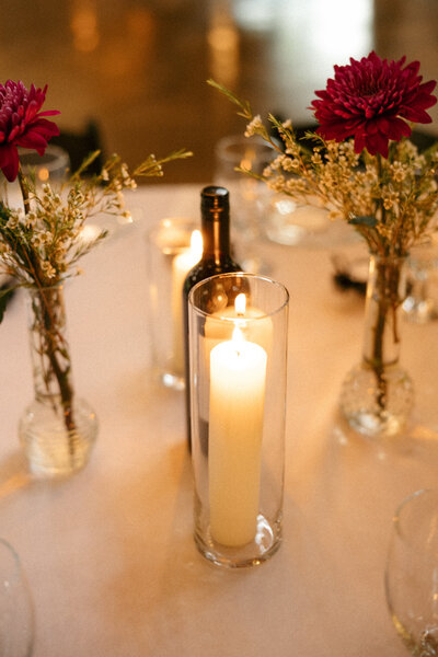 Warm image of candle on wedding reception table in Nashville