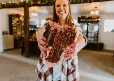 Person holding all natural beef steak