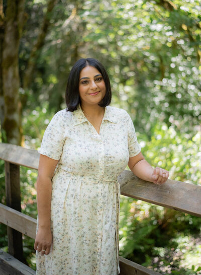 Parm Nizher Healer and Therapist standing on a bridge in the forest