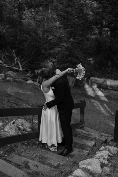 Josh kissing Ally's neck, Ally draping her arms over josh's shoulders, in black and white.