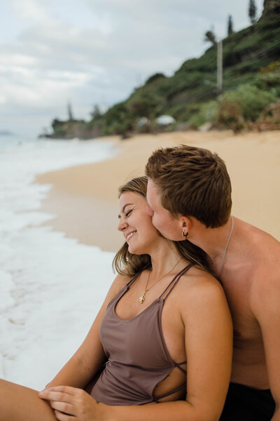 hawaii engagement portraits on the beach in boho colored swimming suits