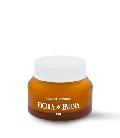 A small amber glass jar of Flora x Fauna Night Cream displayed against a peach-colored background. The jar features minimal white typography, with a white lid, emphasizing the product's clean, natural, and nourishing skincare properties. The design is simple and elegant, reflecting the brand's focus on organic beauty products.