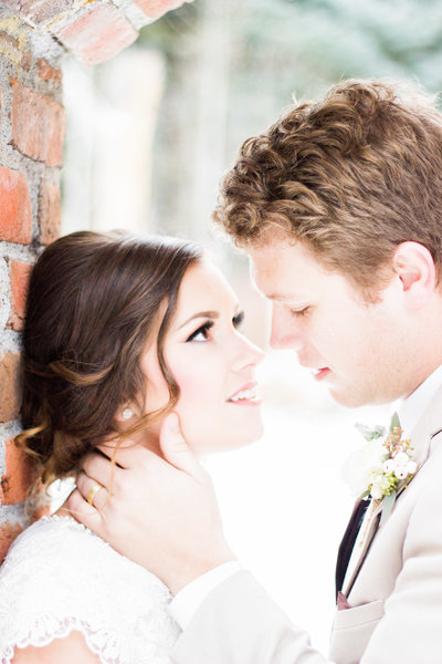 Idaho Wedding Photographer captures indoor wedding where couple embraces