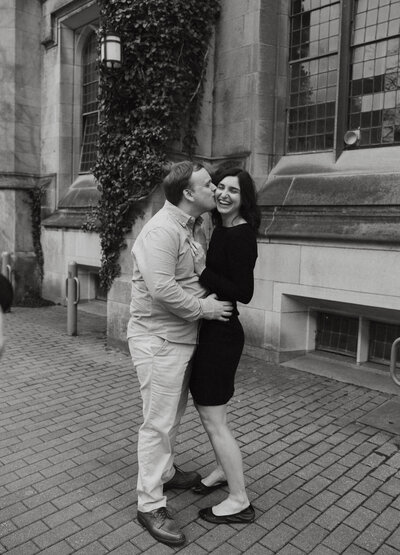 Fiance kissing girl on cheek and making her laugh