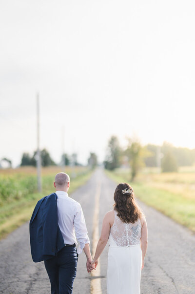 Lovers walking holding hands in rustic wedding