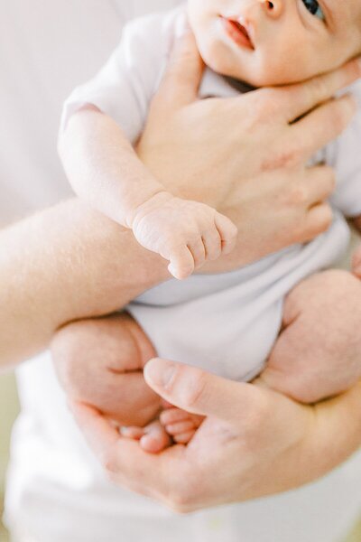 A father holds his newborn baby boy in a portrait by Katelyn Ng, Indianapolis Family and Newborn Photographer