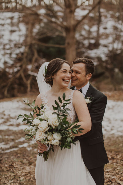 Bride and Groom pose for winter outdoor wedding photo