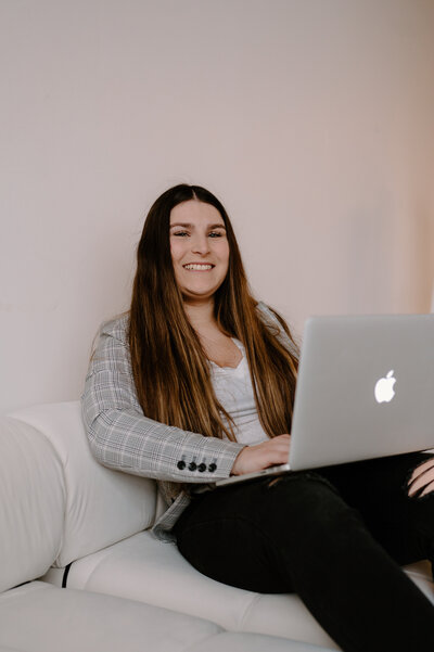 woman sits with laptop