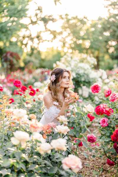 A photography session taken by Bay area photographer shows a woman standing in a field of roses.