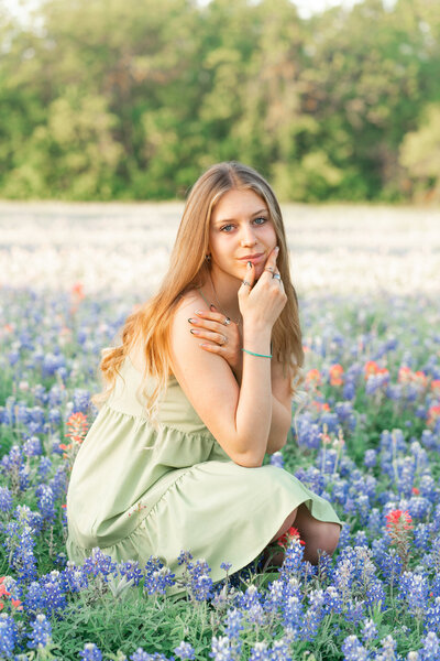 Austin Texas High School Graduate Girl in bluebonnet flowers.