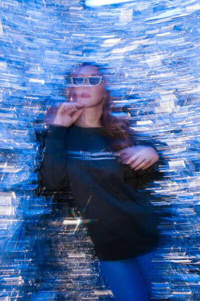 Blurred photo of  Sasha Fedunchak with pearl glasses on