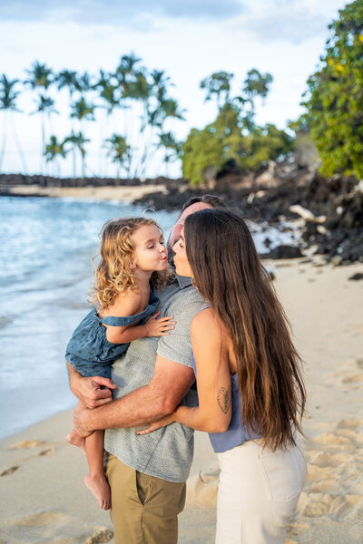 Family playing on beach for portraits with Big Island family photographer