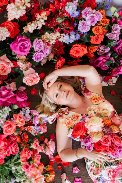 Founder of Bloom Bar surrounded by vibrant flowers, expressing the artistry and emotion behind Austin floral and event design.