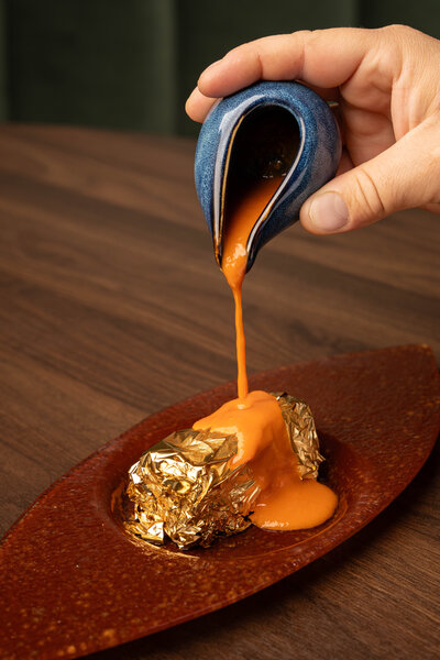 Made with focaccia breadcrumbs, local eggplant roasted on the fire and topped with 24k gold and fresh tomato sauce