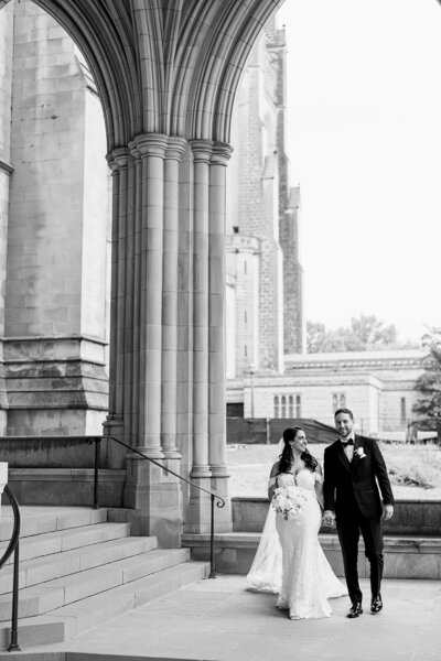 Bride and groom walk up memorial steps at their DC wedding