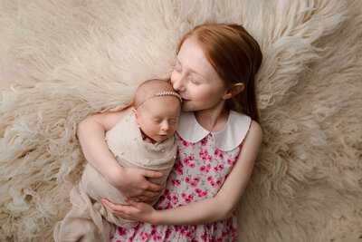 baby girl and older sister captured by nj newborn photographer